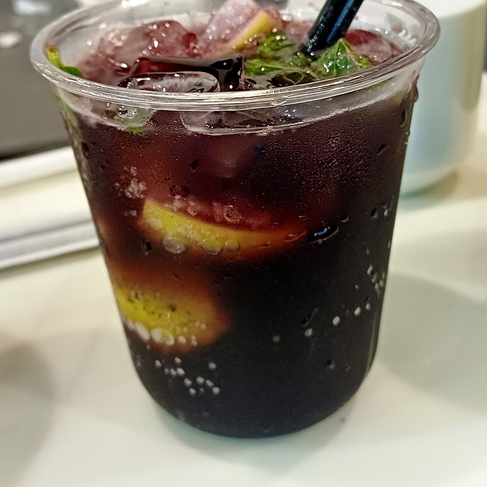 Blueberry mojito with lemon and mint over ice