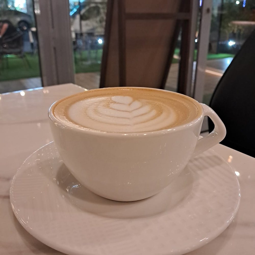 Cappuccino with latte art on a saucer